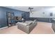 Spacious living room with modern sectional sofa, sleek built-in shelves displaying collectibles, and stylish two-tone walls at 5156 Caspian St, St Cloud, FL 34771