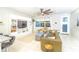 Bright living room featuring tile floors, large windows, a ceiling fan, and modern furniture at 5156 Caspian St, St Cloud, FL 34771