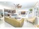 Open concept living room with kitchen view, sleek furniture, and a large entertainment center at 5156 Caspian St, St Cloud, FL 34771