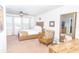 Spacious main bedroom with a large bed, plush seating, and bright windows at 5156 Caspian St, St Cloud, FL 34771