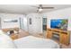 Spacious main bedroom featuring a ceiling fan, a TV, and an en-suite bathroom for added privacy and convenience at 5156 Caspian St, St Cloud, FL 34771