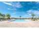 Resort style community pool area lined with lounge chairs and palm trees for relaxing on a sunny day at 5156 Caspian St, St Cloud, FL 34771