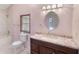 Bathroom featuring a marble vanity, framed mirror, decorative lights, and a tiled shower-tub combination at 5424 Blue Grass St, Orlando, FL 32810