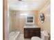 Well-lit bathroom featuring a shower-tub combo and vanity with a dark wood cabinet and granite countertop at 5424 Blue Grass St, Orlando, FL 32810