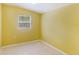 A bright bedroom with a window, light-colored walls, and tile floors that are in good condition at 5424 Blue Grass St, Orlando, FL 32810