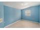 The bedroom offers neutral tile flooring, a window for natural light, and a calming blue paint scheme at 5424 Blue Grass St, Orlando, FL 32810