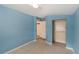 The bedroom features neutral tile flooring, a small window, and a closet for storage at 5424 Blue Grass St, Orlando, FL 32810
