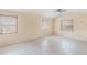 Spacious bedroom with tiled floors, three windows offering lots of natural light, and a ceiling fan at 5424 Blue Grass St, Orlando, FL 32810