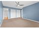Carpeted bedroom features a ceiling fan, window, and closet for practical living at 543 Fairways Dr # B, Ocala, FL 34472