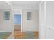 Entryway with hardwood floors, mirror, and artwork adds charm to the home's entrance at 543 Fairways Dr # B, Ocala, FL 34472