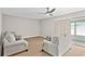 Living Room with neutral walls, carpet, ceiling fan and sliding door to screened in porch at 543 Fairways Dr # B, Ocala, FL 34472