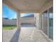 Covered back porch with open view of paved patio and backyard at 5709 Sagunto Dr, Davenport, FL 33897