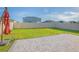 Landscaped backyard with a paver patio, lawn, and privacy fence, ideal for outdoor living at 5709 Sagunto Dr, Davenport, FL 33897
