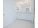 Well-lit bathroom with double sinks and a large mirror for a spacious feel at 5709 Sagunto Dr, Davenport, FL 33897