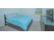 Bedroom featuring a blue bedspread, modern furnishings, neutral carpet, and a window with blinds at 5709 Sagunto Dr, Davenport, FL 33897