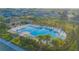 A large community swimming pool with lots of chairs and umbrellas surrounded by lush, tropical landscaping at 5709 Sagunto Dr, Davenport, FL 33897