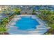 A view of a community pool with lounge chairs and lush greenery, providing a relaxing and inviting atmosphere at 5709 Sagunto Dr, Davenport, FL 33897