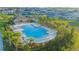 A view of a community pool with lounge chairs and lush greenery, providing a relaxing and inviting atmosphere at 5709 Sagunto Dr, Davenport, FL 33897