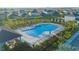 A large community swimming pool with lots of chairs and umbrellas surrounded by lush, tropical landscaping at 5709 Sagunto Dr, Davenport, FL 33897
