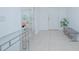 Bright entryway with neutral tile flooring, white walls, a bench, and a modern glass console table at 5709 Sagunto Dr, Davenport, FL 33897