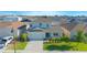 Two-story home featuring a well-manicured lawn and an attached two-car garage in a residential neighborhood at 5709 Sagunto Dr, Davenport, FL 33897