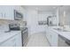 Bright, modern kitchen featuring stainless steel appliances, white countertops, and ample cabinet space at 5709 Sagunto Dr, Davenport, FL 33897