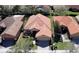 Aerial view of a home with a tile roof surrounded by green lawns and mature landscaping at 603 Russ Pond Dr, Kissimmee, FL 34759