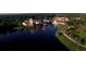 Aerial shot showcases beautiful buildings and a tranquil lake with a fountain feature at 603 Russ Pond Dr, Kissimmee, FL 34759