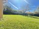 Lush backyard of the home, with grass and foliage at 603 Russ Pond Dr, Kissimmee, FL 34759