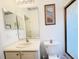 Well lit bathroom with a white sink vanity and decorative artwork at 603 Russ Pond Dr, Kissimmee, FL 34759