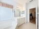 Bathroom featuring a white sink, vanity, soaking tub, and neutral flooring at 603 Russ Pond Dr, Kissimmee, FL 34759
