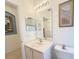 Well lit bathroom with a white sink vanity and decorative artwork at 603 Russ Pond Dr, Kissimmee, FL 34759