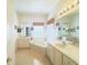 Bright bathroom with a soaking tub, dual vanities, and neutral tile flooring at 603 Russ Pond Dr, Kissimmee, FL 34759