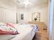 Bright bedroom with a ceiling fan, double door closet, and a floral bedspread at 603 Russ Pond Dr, Kissimmee, FL 34759
