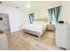 Spacious primary bedroom with wood flooring, ceiling fan, and ensuite at 603 Russ Pond Dr, Kissimmee, FL 34759