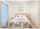 Comfortable bedroom with floral bedding, neutral walls, laminate flooring, and closet at 603 Russ Pond Dr, Kissimmee, FL 34759