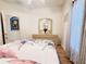 Bright bedroom with a ceiling fan, dresser, and floral bedspread at 603 Russ Pond Dr, Kissimmee, FL 34759