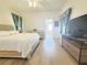 Bright bedroom with ensuite bathroom, and wooden floors at 603 Russ Pond Dr, Kissimmee, FL 34759
