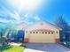Charming home featuring a two-car garage, tiled roof, and well-maintained landscaping at 603 Russ Pond Dr, Kissimmee, FL 34759