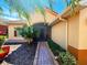 Inviting front entry with brick path and lush landscaping at 603 Russ Pond Dr, Kissimmee, FL 34759