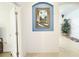 Welcoming hallway with decorative art niche and view to plant and home interior at 603 Russ Pond Dr, Kissimmee, FL 34759