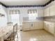 Bright kitchen boasts white cabinets and modern appliances at 603 Russ Pond Dr, Kissimmee, FL 34759