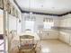 Bright eat-in kitchen features white cabinets, tile floors, and plenty of natural light at 603 Russ Pond Dr, Kissimmee, FL 34759