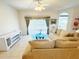 Cozy living area with ceiling fan, neutral walls, and sliding glass door views at 603 Russ Pond Dr, Kissimmee, FL 34759