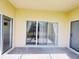A view of the covered patio with access to the yard and a screen enclosure at 603 Russ Pond Dr, Kissimmee, FL 34759