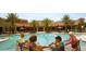 Outdoor pool area with residents enjoying drinks by the pool at 603 Russ Pond Dr, Kissimmee, FL 34759