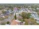 A high-angle aerial of a residential neighborhood showcasing a layout of homes and tree coverage at 606 Forest Dr, Casselberry, FL 32707