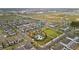 Wide aerial shot showing a townhome community with pool and highway access in the distance at 6067 Blue Lily Way, Winter Garden, FL 34787