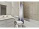 Clean and modern bathroom with a shower-tub combination and a white vanity at 6067 Blue Lily Way, Winter Garden, FL 34787