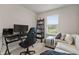 Bedroom features a desk, sofa, and window for a bright workspace or relaxation at 6067 Blue Lily Way, Winter Garden, FL 34787